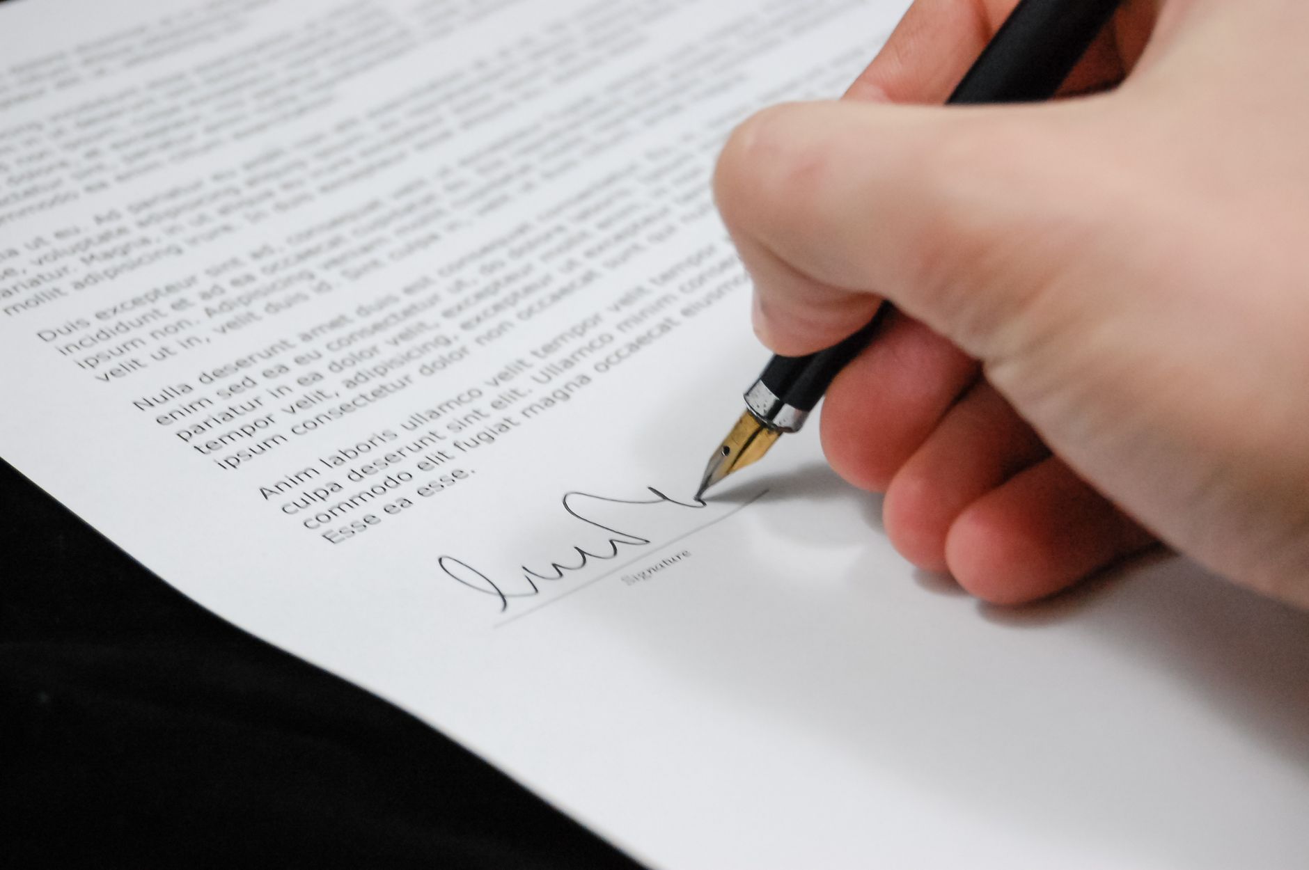 A carefully structured document being signed